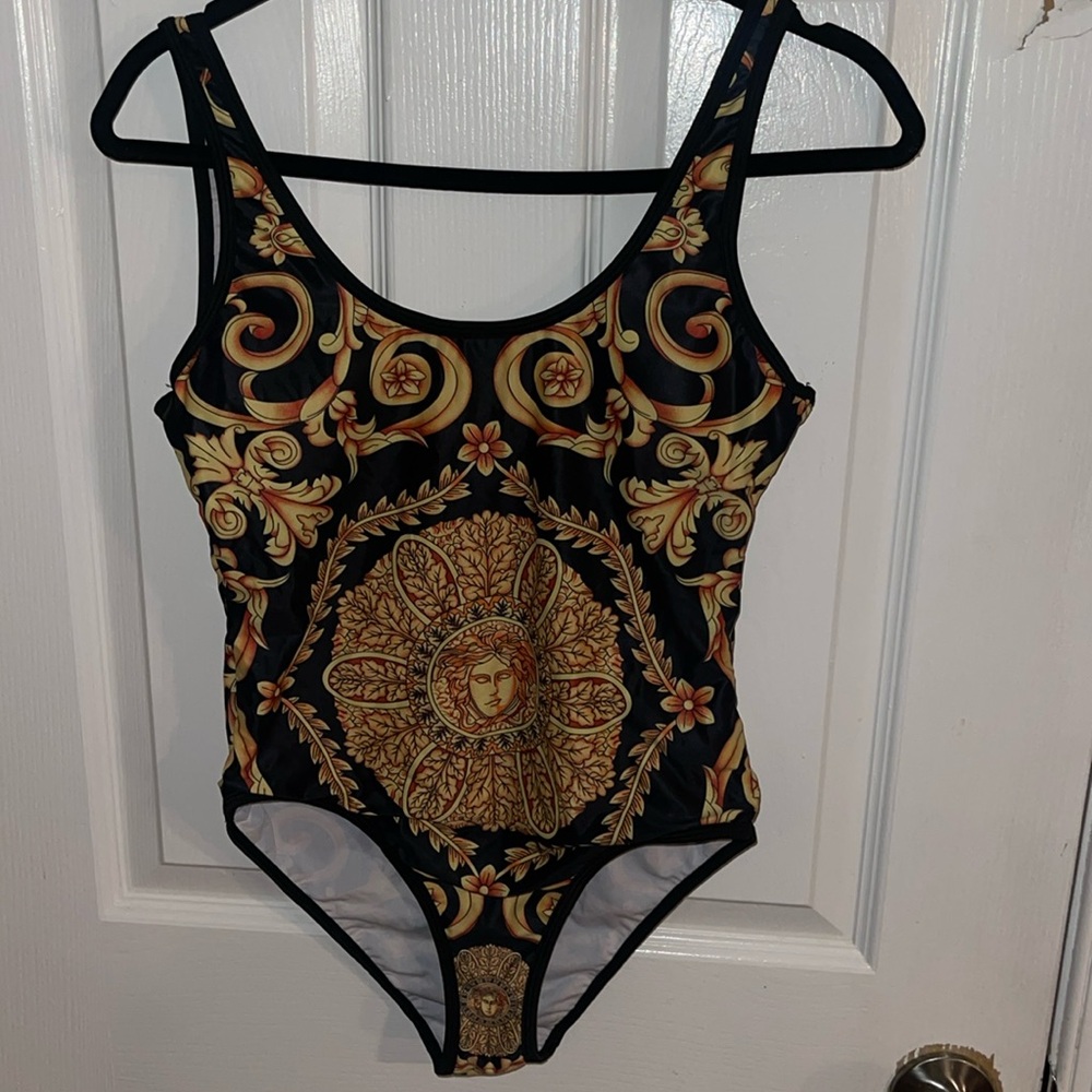 This black and gold bodysuit/ swimsuit is perfect to dress up or down